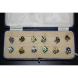 A set of twelve Art Nouveau enamelled metal flower clips, boxed, costume jewellery etc.