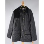 A Ralph Lauren quilted jacket with reinforced suede shoulder pad, length approximately 78cm. size M.