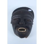 An African carved wood mask, 43 x 30cm. Provenance: Bought by the current vendor in the 1960s.