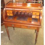 A late Victorian walnut roll top desk,