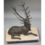 An Art Deco spelter model of a stag, on a marble and onyx plinth, height 34cm, width 34cm.