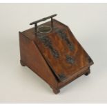 An oak inkstand in the form of a coal scuttle, early 20th century, with brass mounts, height 17cm,