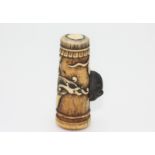 A bone netsuke carved as a dragon drum with a wooden rat, early 20th century, height 4.9cm, width 2.