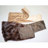 Two fur stoles, both with embroidered flower lining, one dark brown,