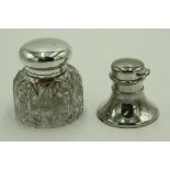 A filled silver inkwell and a cut glass ink well with silver lid.