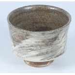 A Bill Marshall tea bowl, in stoneware brushed with Hakeme slip, height 10cm, impressed mark.