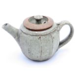 A small stoneware cut sided teapot.