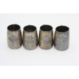 A set of four south east Asian, silver coloured, metal pint mugs,