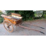 A wooden horse drawn market carriage, with wooden spoked wheels, height 144cm, length 341cm,