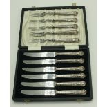 A cased set of six knives with filled silver handles,