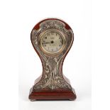 An Art Nouveau mahogany mantle clock, the embossed epns mount with repousse decoration, height 32.