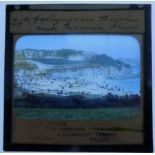A chest of magic lantern slides including hand coloured scenes of Lisbon,