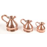 A set of three graduated copper measures, 19th century, impressed pint, 1/2 pint and gill.