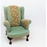 A wing armchair with Arts and Crafts style upholstery,