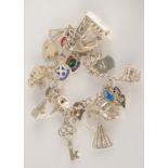 A silver charm bracelet and charms, 66g.