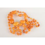 A long Baltic amber necklace with graduated beads, the largest being 29mm, 73g.
