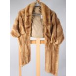 A light brown mink stole, with gold silk lining, length (when worn) 78cm,