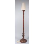 A Chinese mahogany standard lamp, carved with dragons, height 176cm.