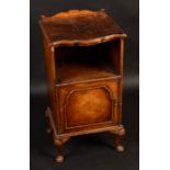 A Queen Anne style walnut bedside cabinet, with shell capped cabriole legs.