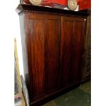 A mahogany wardrobe, 19th century, with a pair of twin panelled doors on a plinth base, height 175.