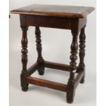 An oak joint stool, the rectangular moulded top on turned legs joined by stretchers, height 58cm,