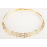 An 18ct contemporary yellow gold collar formed from nine wire strands tied with five diamond set