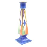 A Clarice Cliff tall square section candlestick, decorated with an early geometric pattern,