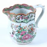 A Chinese Canton porcelain jug, 19th century, decorated with floral sprays and butterflies,
