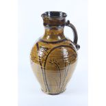 A large Doug Fitch slipware jug, the ribbed body with a yellow and brown glaze, impressed DF mark,