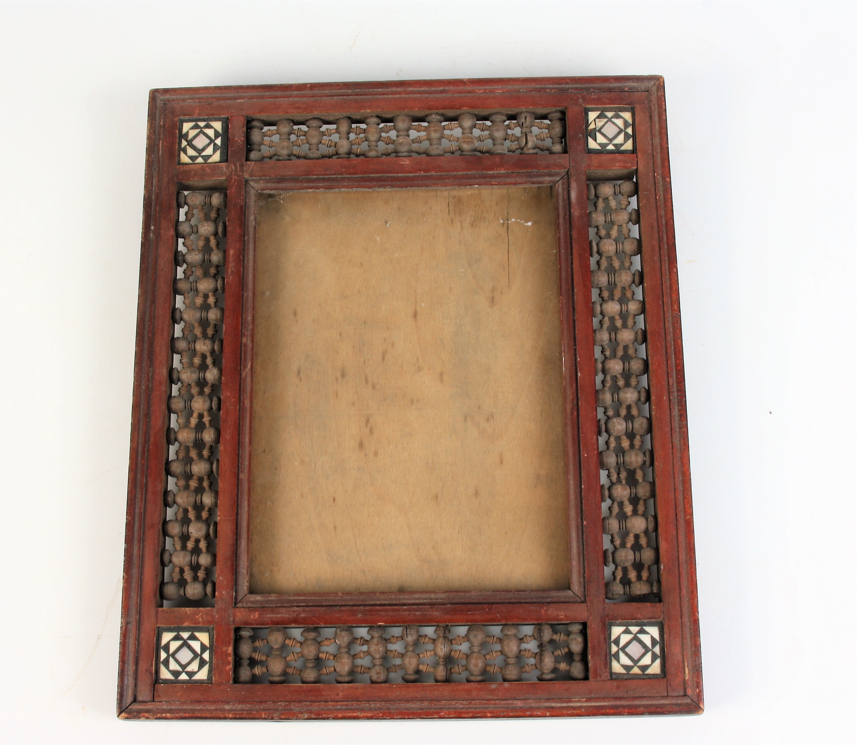 A Syrian wood picture frame, early 20th century, with four square panels with bone,