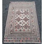 A Soumakh rug, the ivory field with three rows of two medallions within multiple borders,