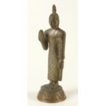 A bronze figure of buddha, standing on a circular plinth base, height 23cm.