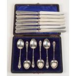A cased set of six fancy silver coffee spoons,
