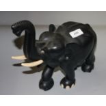 A Ceylonese ebonised elephant, height 29cm, width 30cm, depth 12.5cm.