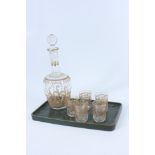 A cut glass gilt decorated decanter and five matching glasses,