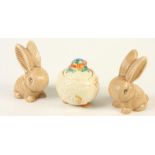 A Clarice Cliff 'Celtic Harvest' preserve jar and cover, height 11cm and two Sylvac rabbits, No 990,