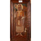A carved wood icon, depicting a priest holding a staff and books, framed,