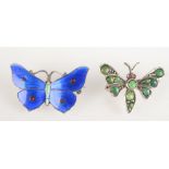 Two butterfly brooches.