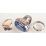 A sapphire crossover ring and two other rings.