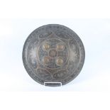 A Persian circular metal shield, diameter 37.5cm, depth 6.5cm.