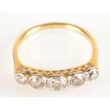 A yellow gold ring set five diamonds in platinum collet setting.