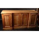 A pine sideboard with recessed break front and four plain panelled doors, width 173cm.