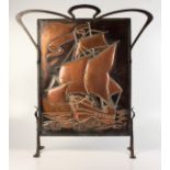 An Arts and Crafts Hayle copper and wrought iron firescreen, height 77.5cm, width 71.5cm.