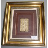 A carved ivory book cover, depicting the crucifixion, mounted on card and framed,