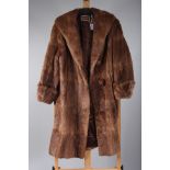 A lady's fur coat, label inscribed 'The Arctic Fur Stores, Crouch End'.