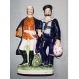 A Victorian Staffordshire group of a soldier and sailor standing arm in arm, height 30.5cm.