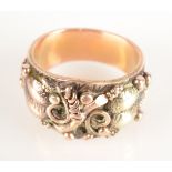 An unusually ornate American 10ct gold ring in two colours with leaves and vines marked 18 but