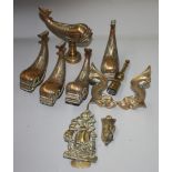 Five brass stylised dolphins and other brassware.
