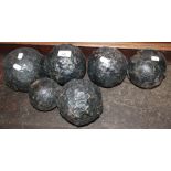 Six black painted cast iron cannonballs.