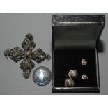 A cross form brooch set with faceted 9 cut stone in antique style,